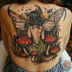 the back of a woman's body with mushrooms and fairy tattoos on her shoulder