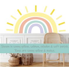 a chair and potted plant in front of a rainbow wall decal