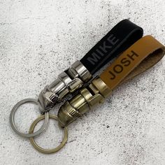 a couple of keys that are on top of a keychain and some sort of lighter