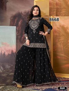 In the depths of charcoal black, the embroidered sharara and kurta set emerges with stunning elegance. The dark fabric, adorned with intricate embroidery, shimmers like stardust against the night sky. Each delicate stitch weaves a story of sophistication and mystery, while the kurta drapes with regal grace and the sharara flows with fluid allure. Adorned in this exquisite ensemble, she embodies a timeless allure, radiating both depth and grace.  Occasion: Garara,sharhara, suits,pakistani suits,p Black Semi-stitched Palazzo Set With Mirror Work, Black Georgette Sharara For Festive Occasions, Black Bollywood Style Georgette Sharara, Black Georgette Bollywood Sharara, Festive Black Georgette Sharara, Bollywood Style Black Palazzo Set For Festive Season, Bollywood Style Black Palazzo Set For Festive Occasions, Bollywood Style Black Palazzo Set For Eid, Festive Bollywood Style Black Palazzo Set