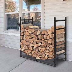 a stack of firewood sitting in front of a window next to a pile of logs