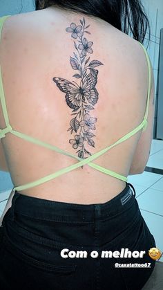 the back of a woman's body with flowers and butterflies on her upper back