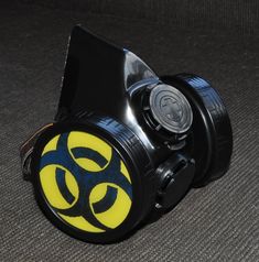 Black Cyber Mask made from PVC and plastic .   Gas Mask has inserts in the shape of a Yellow Sign Biohazard , Inserts a removable easy  D = 2.76 inch. (70 mm)  .   Cyber Goth Mask adult sized. An adjustable elastic band long and strong for easy fit and comfort on anyone. You can choose additional other biohazard , radiation , skull symbols by adding it from my other listing : https://www.etsy.com/listing/1741175014/biohazard-simbol-biohazard-inserts-cyber?click_key=2f9ef91c13e1e2540e1d76a4f61d7aeff83446ba%3A1741175014&click_sum=7b7078f8&ref=shop_home_active_2  Modified for easy breathing. All modification are made by hand ! Hi quality, by ZHOS ! Item new without tags. Good for fashion , festivals, parties, cyber gothic look, like gift . Shipping: We ship within 1-2 business days after clea Black Masks For Cosplay Events, Black Masks And Prosthetics For Cosplay Events, Black Punk Cosplay Costume For Themed Events, Black Mask Cosplay Costume For Cosplay Events, Black Cyberpunk Mask For Costume, Cyberpunk Black Mask For Costume, Plastic Halloween Cosplay Costume Accessories, Black Sci-fi Cosplay Costume For Halloween, Plastic Costume Accessories For Cosplay Halloween