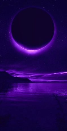 an eclipse in the night sky over water