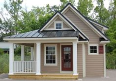 a small house with a porch and front door