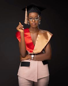 a woman in a graduation cap and gown posing for the camera with her hand on her hip