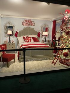 a bedroom decorated for christmas with red and white decor