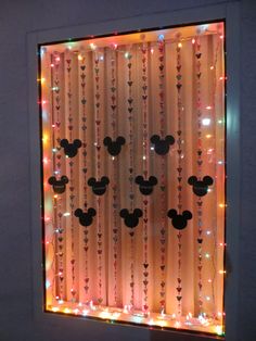 a lighted window with mickey mouse heads on it