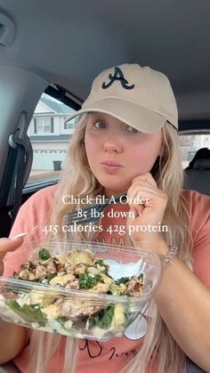 a woman sitting in the back seat of a car holding a bowl of food