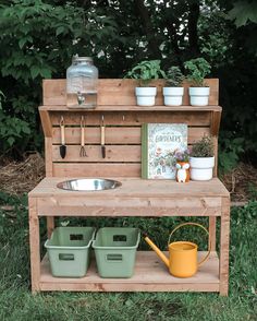 an outdoor potting bench with pots and gardening tools