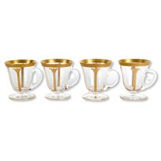 four glass cups with gold rims on them