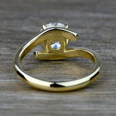 a close up of a gold ring with a diamond on the top and bottom part