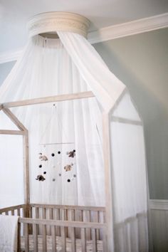 a white canopy over a crib in a baby's room