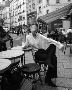 black and white photograph of a man sitting at an outdoor table