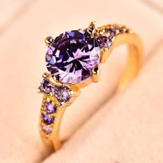 Material: Cubic Zirconia Surface Width: 6mm Setting Type: Prong Setting Occasion: Engagement, Wedding, Anniversary, Birthday, Special Occasion Amethyst Birthstone Ring, Amethyst Birthstone, Ring Settings Types, Purple Crystal, Purple Band, Solid Gold Jewelry, Purple Crystals, Engagement Jewelry, Crystal Stone