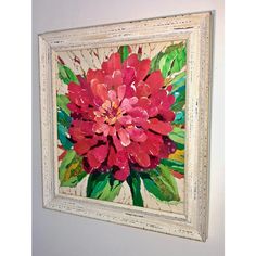 a red flower is displayed in a white frame on the wall next to a toilet