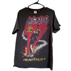 Ac Dc World Tour 77 Junkfood 2013 Band Tee Unisex Size Small Black Graphic T Shirt Great Used Condition Flay Lay Measurements 20 Inches - Pit To Pit 8 Inches - Arm Length 26 Inches Length New Item Will Be Noted As Nwt -(New With Tag) Or Nwot (New Without Tag) Preloved In Great Condition, No Flaws Unless Noted. Measurements Noted And Material Listed If Not Shown In Photos. Smoke Free/Pet Free Home Please Review All Photos Before Placing Order And Ask Questions If Needed. I Usually Ship Same Day I Band Merch Short Sleeve Graphic T-shirt, 80s Band Tees, Washed Black Band Merch T-shirt With Graphic Print, Band Logo T-shirt Short Sleeve Fan Apparel, Acdc Tee, Acdc Graphic Tee, Dc World, Graphic Tees Vintage, Retro Tee