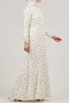 Elevate your wardrobe with our elegant crepe polyester maxi dress, adorned with a delicate ditsy floral print. This sophisticated piece features a high neck and gracefully flared sleeves, offering a refined and modest look. The standout feature is the layered peplum detail at the waist, adding a touch of flair and femininity. The dress is unlined, providing a lightweight and breathable option perfect for warm weather. Embrace the exquisite design and make a stylish statement with this beautifull Elegant Maxi Floral Dress With Ditsy Print, Elegant Flowy Maxi Dress With Ditsy Floral Print, Elegant Ditsy Floral Print Maxi Dress, Elegant Long Sleeve Maxi Dress With Ditsy Floral Print, Elegant White Midi Dress With Ditsy Floral Print, White Elegant Dress With Ditsy Floral Print, Feminine Cream Floral Print Maxi Dress, Elegant White Ditsy Floral Print Dress, Feminine Cream Maxi Dress With Floral Print