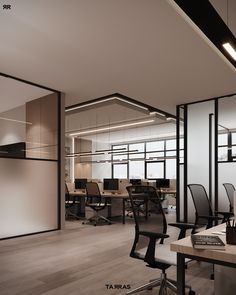 an empty office with chairs and desks in front of glass partitions on the wall