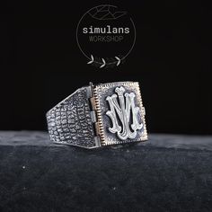 Discover the perfect blend of elegance and personalization with our Sterling Silver Monogram Ring. Expertly crafted from 925 sterling silver, this unique piece features a hinged, square design that opens to reveal a customizable area inside. The exterior is adorned with an intricate bark texture, giving it a distinctive and rugged look. This ring is perfect for engraving initials, monograms, logos, or symbols, making it a thoughtful and personalized gift for any occasion. Whether you're commemor Luxury Silver Initial Ring Hallmarked, Luxury Sterling Silver Signet Ring, Luxury Silver Initial Ring With Polished Finish, Luxury Silver Hallmarked Initial Ring, Luxury Monogrammed White Gold Signet Ring, Luxury Stamped 925 Signet Ring For Wedding, Luxury 925 Stamped Signet Ring For Wedding, Luxury Silver Initial Ring In Sterling Silver, Luxury Sterling Silver Initial Ring In Silver