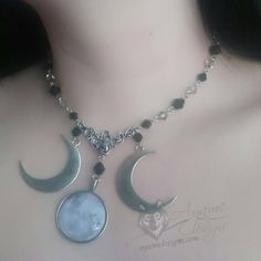 Introducing the Amaris necklace! This piece features a full moon cabochon pendant with large crescent moon pendants on either side with black and grey glass beads all around. It comes with an adjustable chain at the back so you can wear it whichever length you prefer. The necklace is 37.5-42.5cm in length - if you need me to make it longer or shorter, just add a note with the length you want it! All metal findings except the charms are stainless steel. All the charms are coated with Everbrite co Black Moon Phase Necklaces For Festival, Black Moon Phase Necklace For Festival, Black Moon Phase Jewelry For Festivals, Black Moon Charm Jewelry For Festivals, Black Jewelry With Moon Charm For Festivals, Black Crescent Jewelry For Festival, Black Moon-shaped Sun And Moon Jewelry, Black Moon Jewelry With Sun And Moon Design, Black Moon-shaped Jewelry With Sun And Moon Design