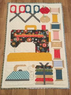 a quilted table runner with sewing supplies on it