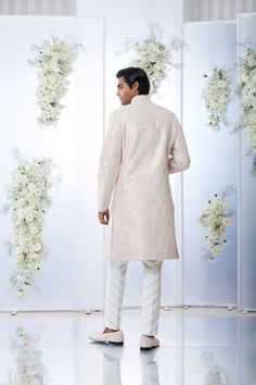 This sherwani set features all over gota embroidery on powder pink raw silk base. It is paired with a matching silk kurta and an off-white cotton trouser. Completing footwear is also available. From Seema Gujral's Tuscan Summer collection. DELIVERY TIMEPlease allow 8-12 weeks for your outfit to arrive.FABRIC DETAILSRaw SilkProfessional cleaning only. Formal Pink Kurta With Naqshi Detailing, Pink Naqshi Kurta For Reception, Festive Pink Sherwani With Gota Work, Pink Sherwani With Gota Work For Festivals, Eid Pink Raw Silk Sherwani, Sherwani With Gota Work For Reception, Traditional Pink Sherwani With Gota Work, Straight Kurta Sherwani With Gota Work For Reception, Pink Sherwani With Gota Work For Diwali