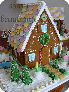 a gingerbread house is decorated with icing and candy