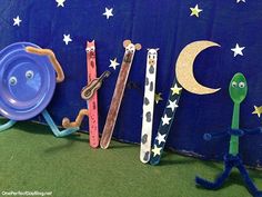 three children's toothbrushes are lined up in front of a blue sign