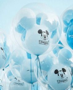 many clear balloons with mickey mouse stickers on them