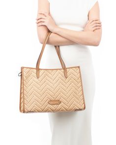 A women's designer tote bag for sale online which is lightweight and durable, as well as chic! Woven raffia in a bold chevron pattern is framed with rich calf leather. The boxy, elongated shape sits handsomely on your shoulder, closing securely with a top zipper. The advantage of this east-west silhouette is that it is sufficiently large to hold quite a lot without dwarfing gals of petite stature. An outer pocket on reverse is for easy access to phone or glasses. Inside: durable canvas lining an Designer Straw Bag With Top Carry Handle, Luxury Double Handle Straw Bag, Modern Straw Bag For Errands, Designer Straw Bag For Daily Use, Elegant Rectangular Straw Bag For Errands, Designer Brown Satchel, Natural Color Satchel For Shopping, Modern Straw Shopping Bag, Elegant Brown Straw Bag For Errands