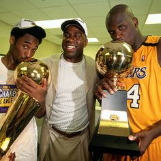 three basketball players holding trophies in their hands