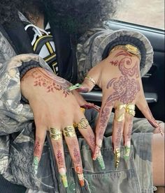 a person with tattoos on their hands in a car