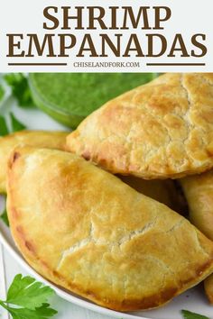 homemade shrimp empanadas on a plate with parsley