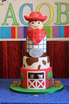 a three tiered cake with a cow on top