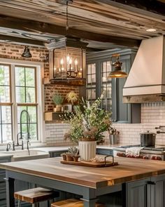 a kitchen with an island, stove and sink in it's centerpieces