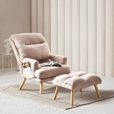 a chair and ottoman in front of a window with vertical blinds