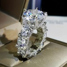 a diamond ring is sitting on top of a box