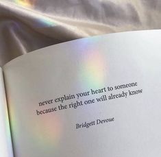 an open book with a quote on the page and light shining through it in the background