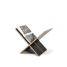 a magazine holder with a knife sticking out of it's side, against a white background