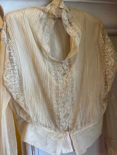 A handmade, very romantic antique Edwardian creamy double-layered blouse. Beautiful embroidery on tulle, and silk-lined bodice. Long sleeves. Pretty floral design with hand-made buttoned cuffs. Measurements:  56cm underarm to underarm.  46cm in length.  Very well preserved and in lovely wearable condition. Freshly laundered. An authentic period piece and gorgeous for use or display. Embroidery On Tulle, Period Piece, Womens Costumes, Silk And Lace, Layered Blouse, Edwardian Fashion, Women's Costumes, Beautiful Embroidery, Embroidered Blouse