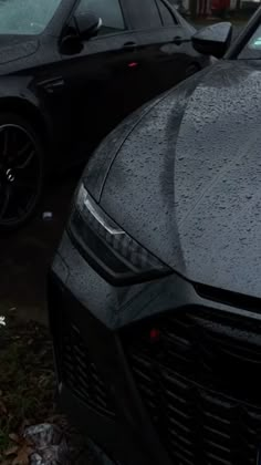 two cars parked next to each other in the rain