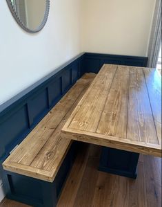 a wooden table and bench in a room