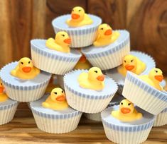 small cupcakes with yellow rubber ducks in them