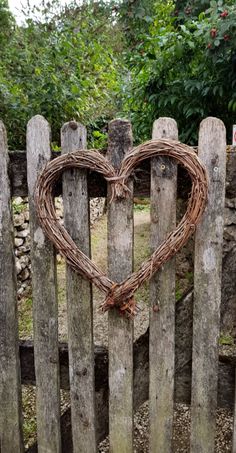 a wooden fence with a heart shaped wreath on it