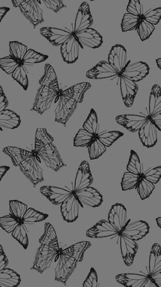 black and white butterflies flying in the air on a gray background, seamless pattern