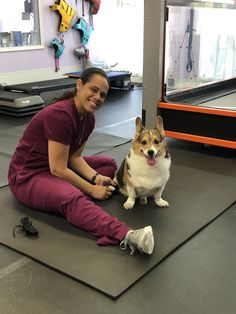 a woman sitting on the floor with her dog