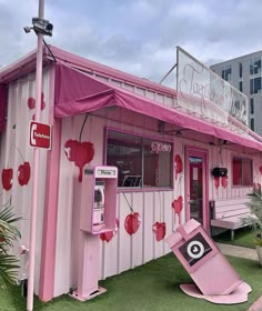 a pink building with a broken phone booth