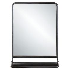 a black metal frame mirror sitting on top of a table