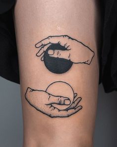 two hands holding an object in the shape of a ball and another hand reaching for it